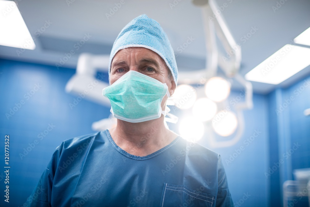 Portrait of surgeon standing in operation room Portrait of surgeon standing in operation room