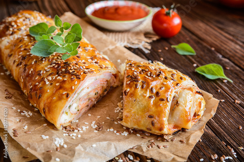 Photos Savory strudel with ham, cheese, tomato sauce and herbs