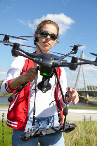 woman holding drone uav over a field. Aerial video and photogra