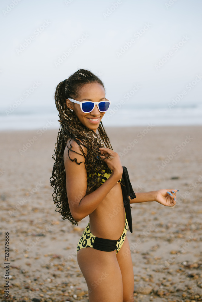 Sexy stylish brazilian woman in fashion bikini enjoying vacation at the  beach. Black female beautiful model with dreadlocks and trikini exotic  swimwear. Stock Photo | Adobe Stock