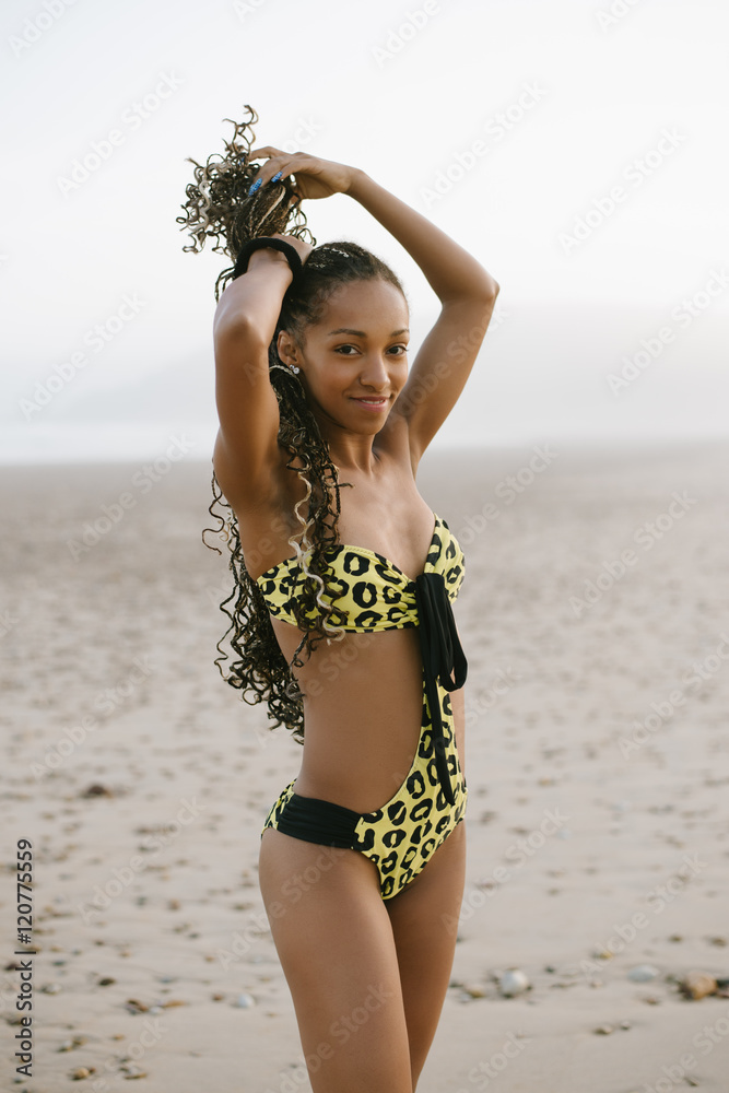 Sexy stylish brazilian woman fashion bikini enjoying vacation the beach. Black female model with and trikini exotic swimwear. Stock Photo | Adobe Stock