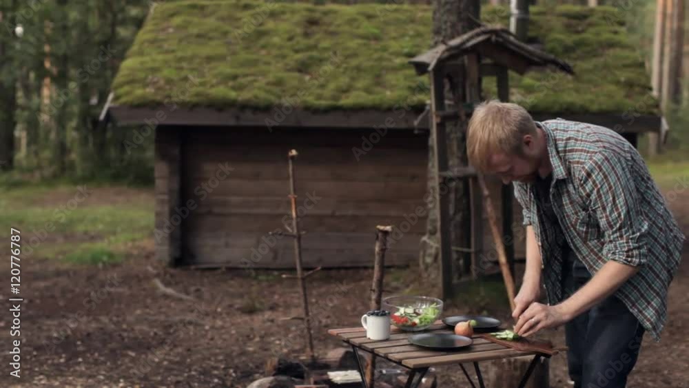 Man Prepares Vegetarian Salad on Nature, Camping Man Prepares Vegetarian Salad on Nature, Camping