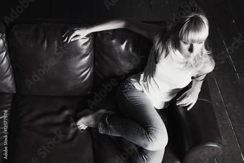 Young woman sitting on sofa
