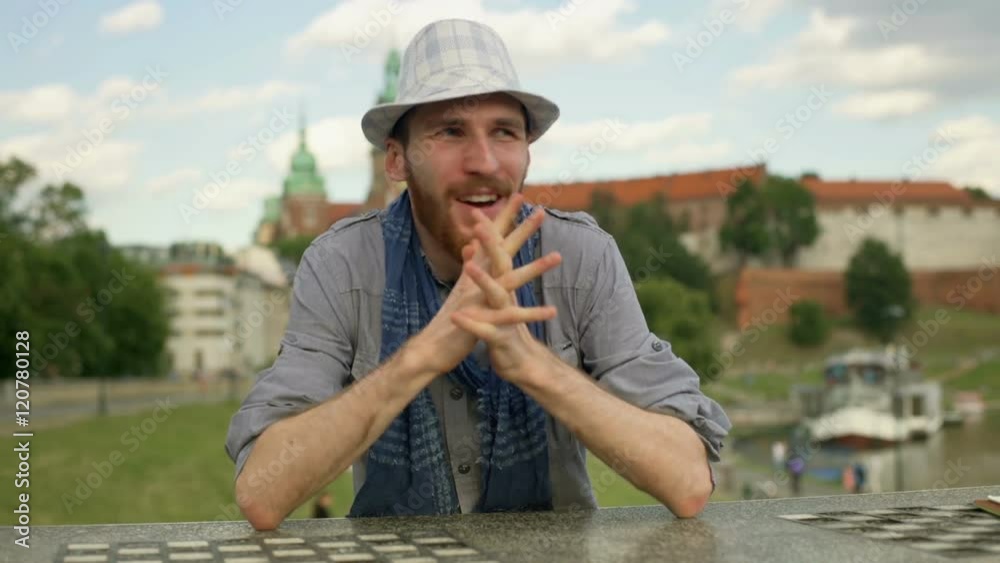 Joyful tourist sitting by the river and having a success
Joyful tourist sitting by the river and having a success