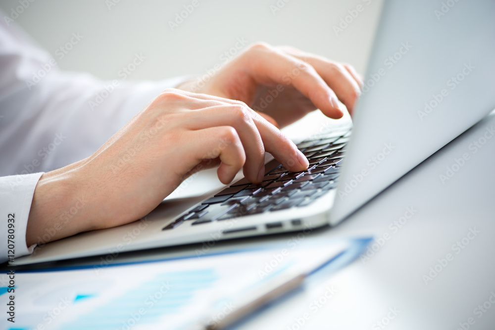 Close-up of hands of business man typing on a laptop. Close-up of hands of business man typing on a laptop.