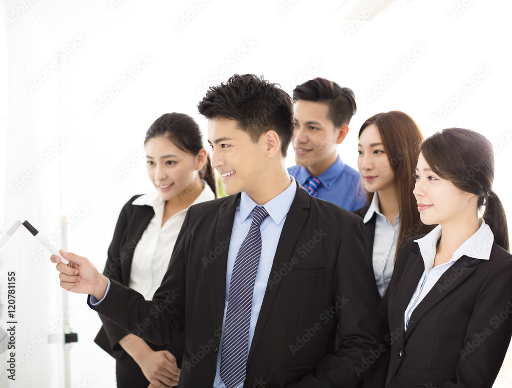 Businessman presenting new project to partners in office Businessman presenting new project to partners in office