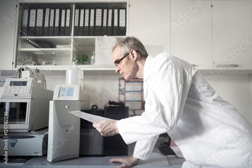 Male meteorologist reading data at weather station laboratory
