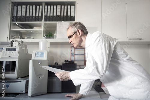 Male meteorologist reading data at weather station laboratory photo