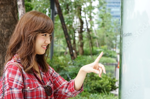 Young Asian woman checking directions with a Map