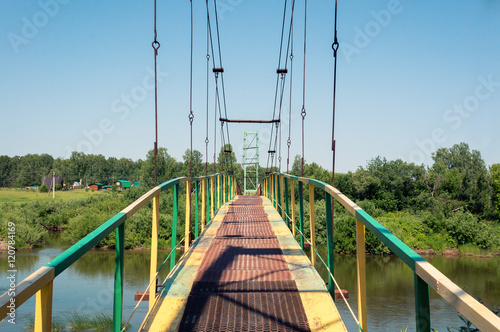 Rural landscape with old metal bridge 