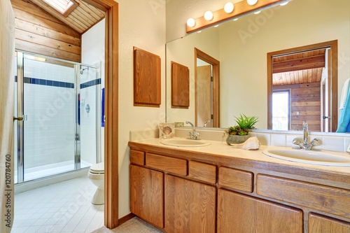 Bedroom interior with vanity cabinet  two sinks and large mirror.