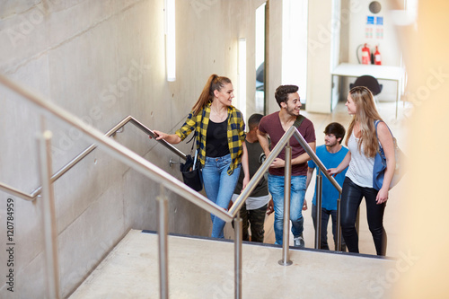 Group of students moving up stairway at higher education college photo
