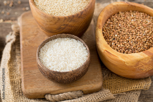 rice, quinoa and buckwheat on wooden surface