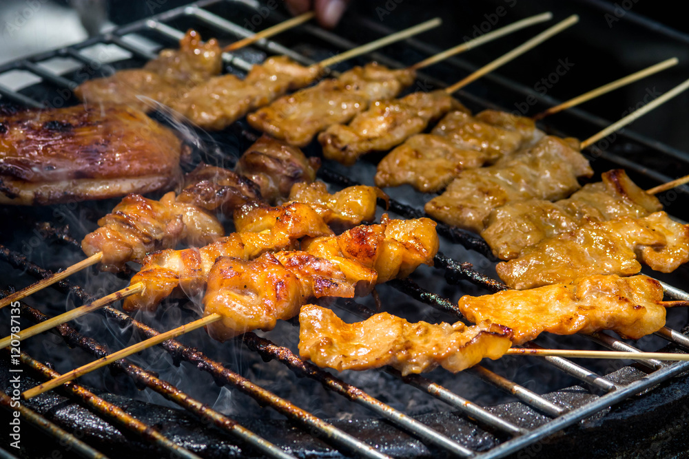 Grilled chicken on the flaming grill