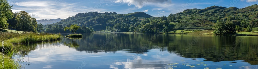 Wide panorama at Rydal Water in the Lake District on a calm summer morning.