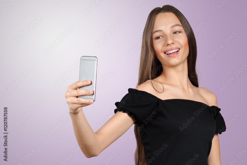 Beautiful young woman is making selfie photo with smartphone Beautiful young woman is making selfie photo with smartphone