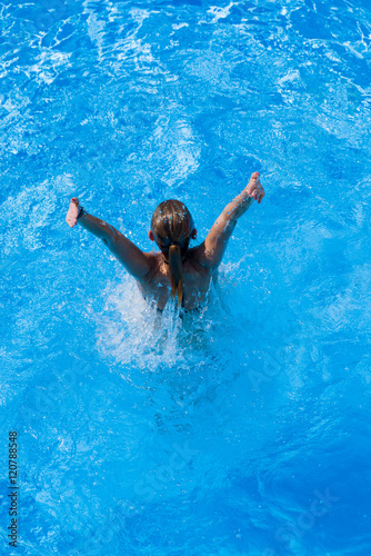 woman with swimsuit swimming on a blue water pool