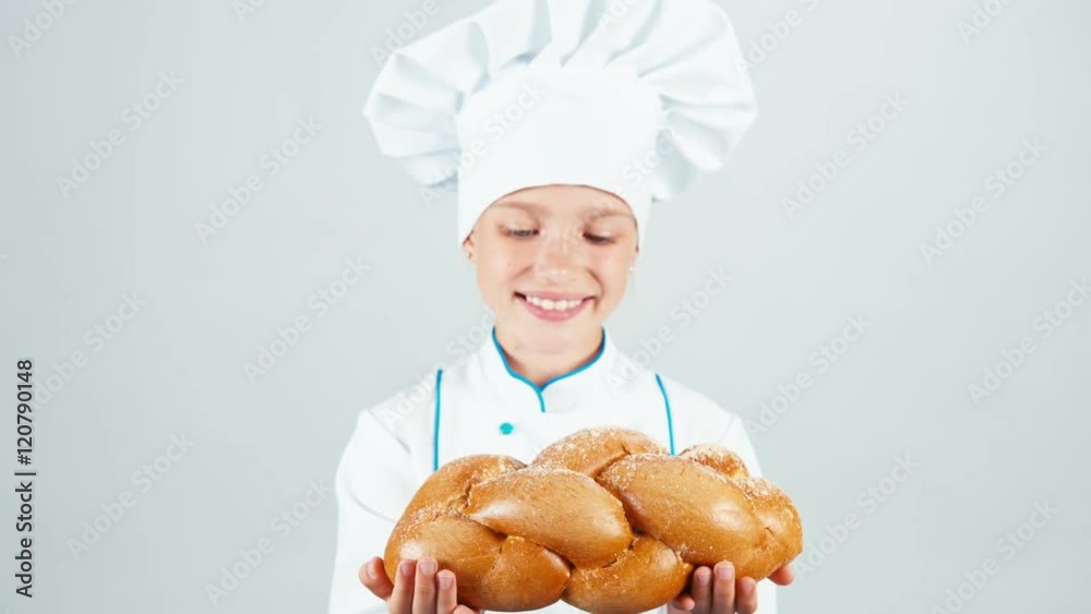 Portrait young baker holds braided bread and gives loaf you at camera and smiling isolated on white background Portrait young baker holds braided bread and gives loaf you at camera and smiling isolated on white background