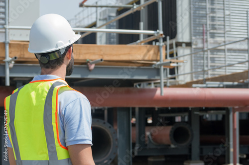 Mechanical engineer during a site visit, checking cooling towers installation