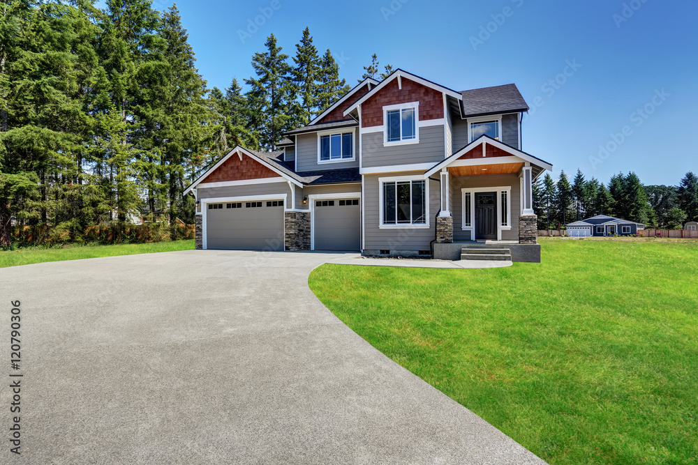 Craftsman American house with rocks trim, garage and concrete floor porch