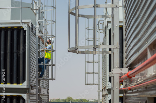 Mechanical engineer during a site visit, checking cooling towers installation