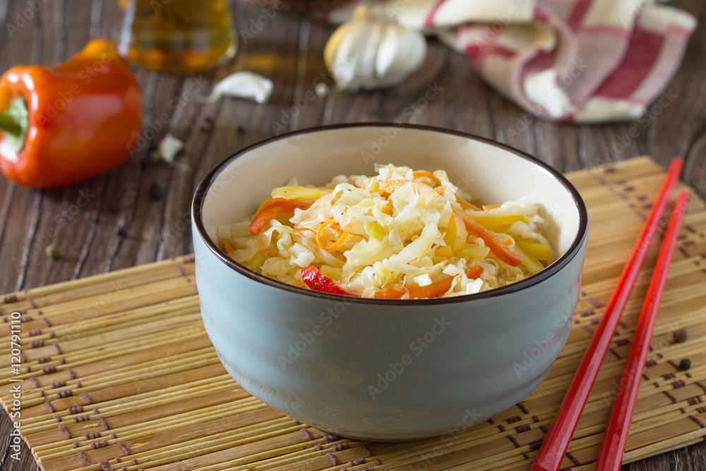 Korean salad of cabbage, carrots, sweet peppers - kimchi in an A Korean salad of cabbage, carrots, sweet peppers - kimchi in an A