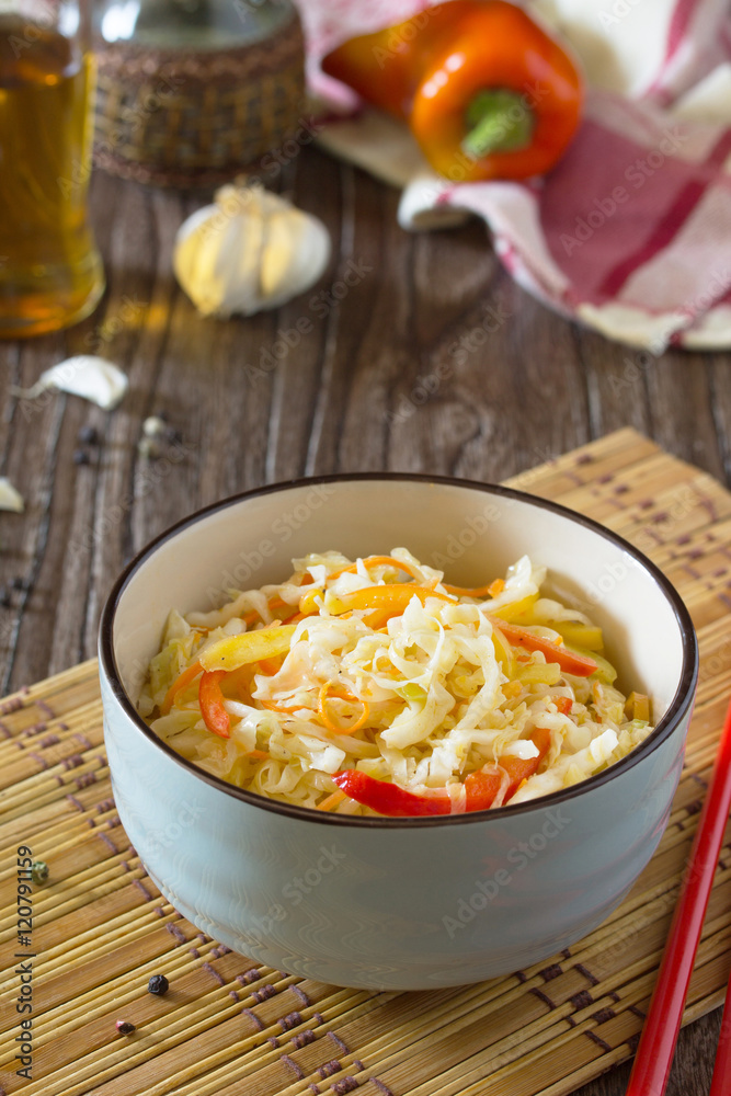 Korean salad of cabbage, carrots, sweet peppers - kimchi in an A Korean salad of cabbage, carrots, sweet peppers - kimchi in an A