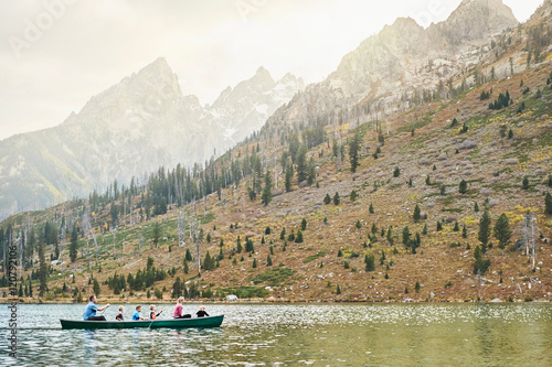 Family in canoe trip on calm waters of String Lake, USA