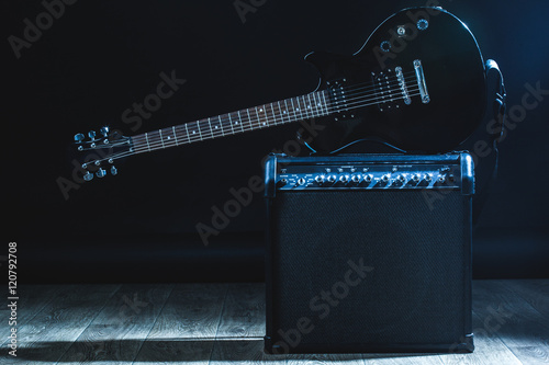 electric guitar and classic amplifier on a dark background