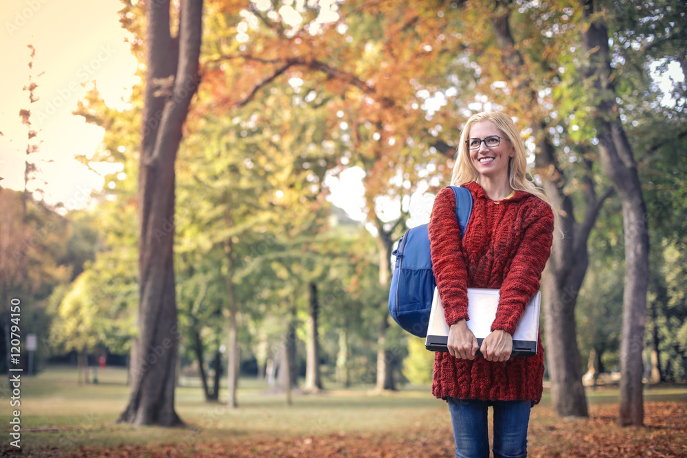 Happy woman at the park in an autumn day Happy woman at the park in an autumn day