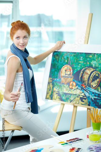 Portrait of a young artist with her picture