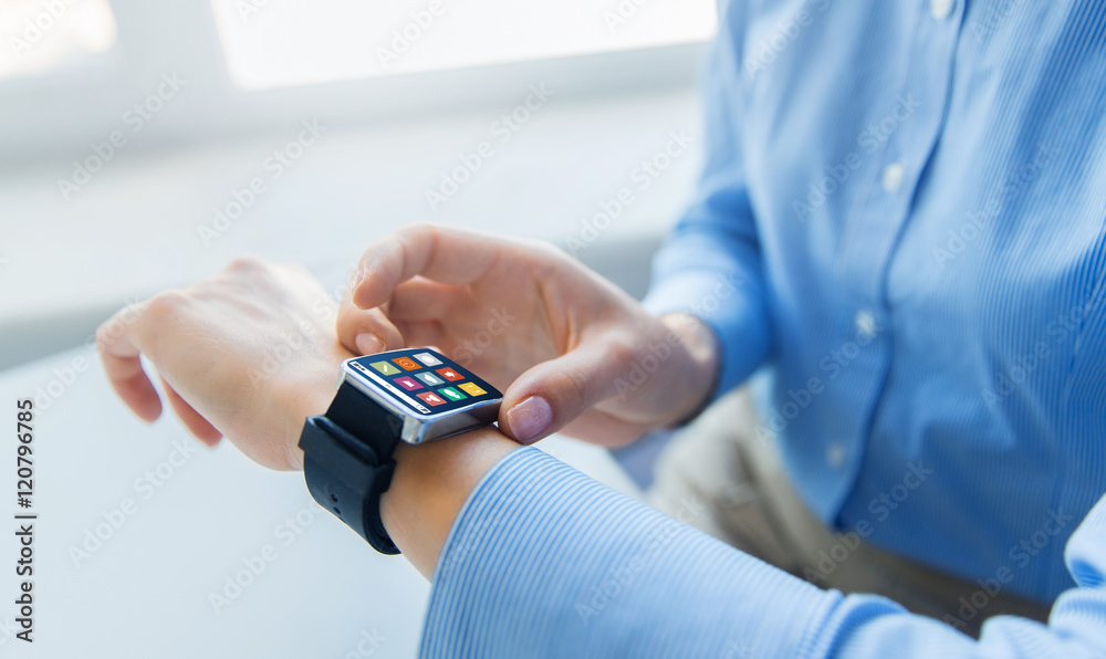 close up of hands with menu icons on smart watch