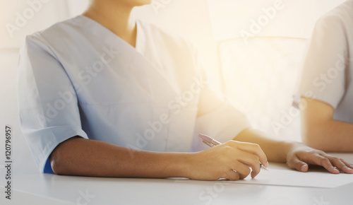 close up of doctor taking notes at hospital