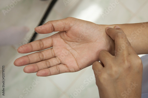 Fototapeta Naklejka Na Ścianę i Meble -  Doctor hand check on wrist pulse