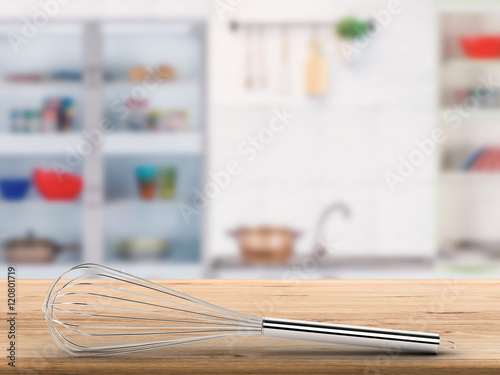 wire whisk on counter with kitchen background © phonlamaiphoto