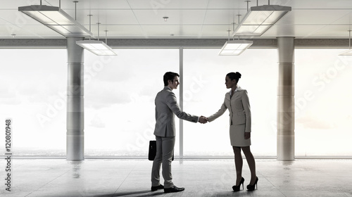 Business partners handshake . Mixed media