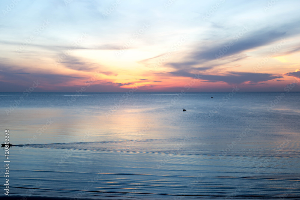 Fototapeta premium beautiful sunrise with fishing boat in the sea