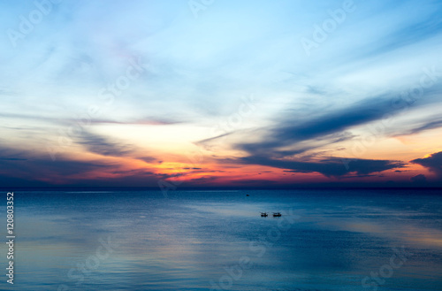 beautiful sunrise with fishing boat in the sea © bignai