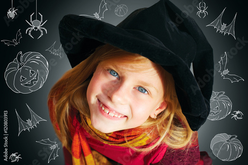 Halloween funny little girl looking at camera black background