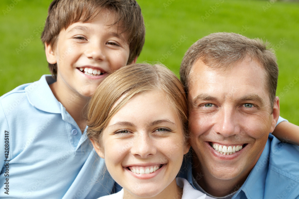 Portrait of happy family of three looking at camera and smiling Portrait of happy family of three looking at camera and smiling