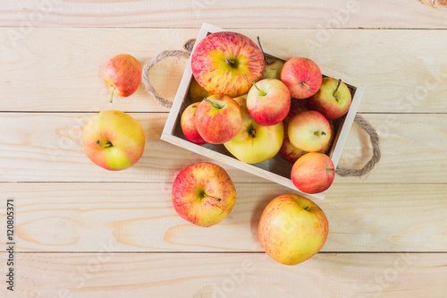 Fresh Apples in a wooden crate on wooden table background