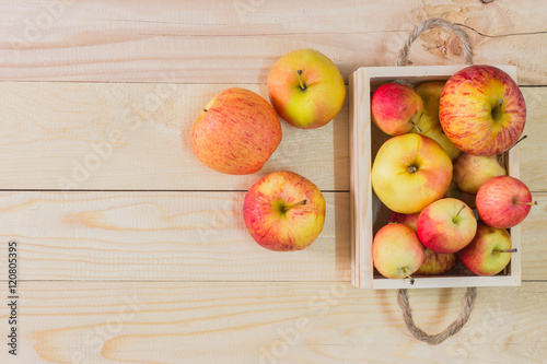 Fresh Apples in a wooden crate on wooden table background