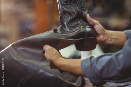 Cobbler making leather boots 