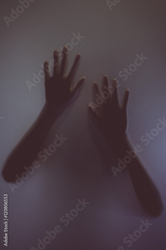 The silhouette of the hand on sand glass