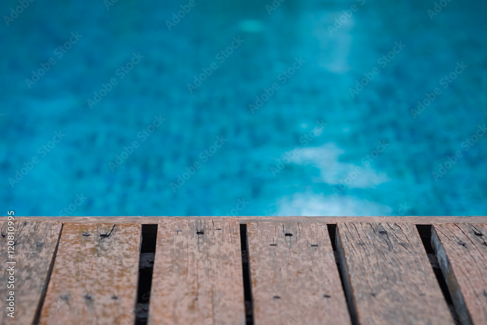 Wooden deck of the swimming pool with rain drops, ideal for back
