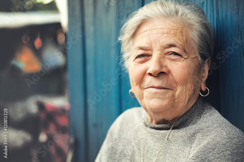 Obraz na plátně Happy old senior woman smiling outdoor