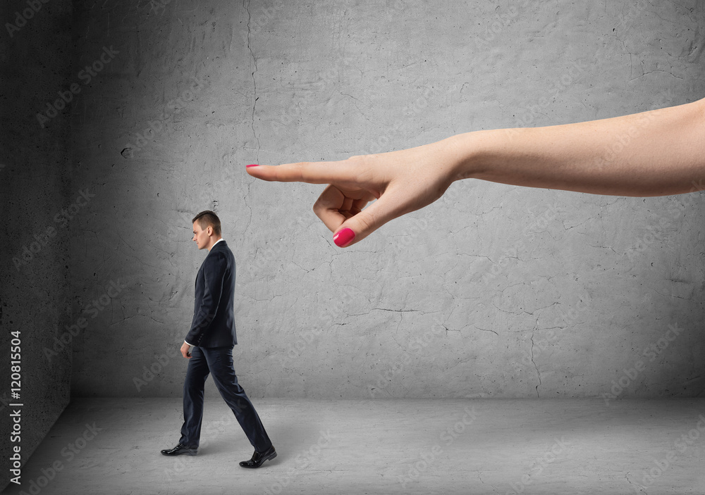 Businessman following direction that big female's hand pointing out Businessman following direction that big female's hand pointing out