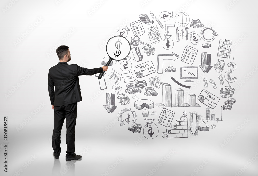 Businessman looking at business doodles through a magnifier and seeing dollar sign Businessman looking at business doodles through a magnifier and seeing dollar sign