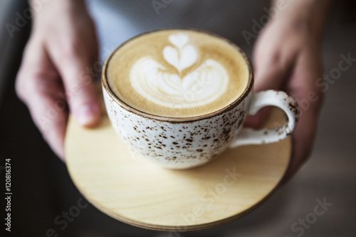 Coffee cup. Latte art in cafe. Barista offering coffee