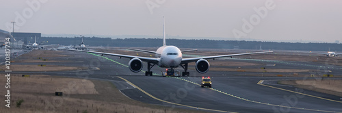 airplane beeing towed on a runway